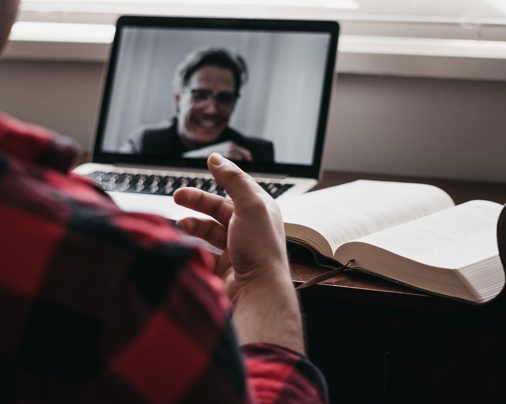 A picture of a medical school graduate meeting with a Residents Medical team member over a video call. Residents Medical